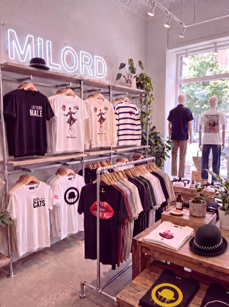 Il negozio Milord con insegna al neon e t-shirt esposte